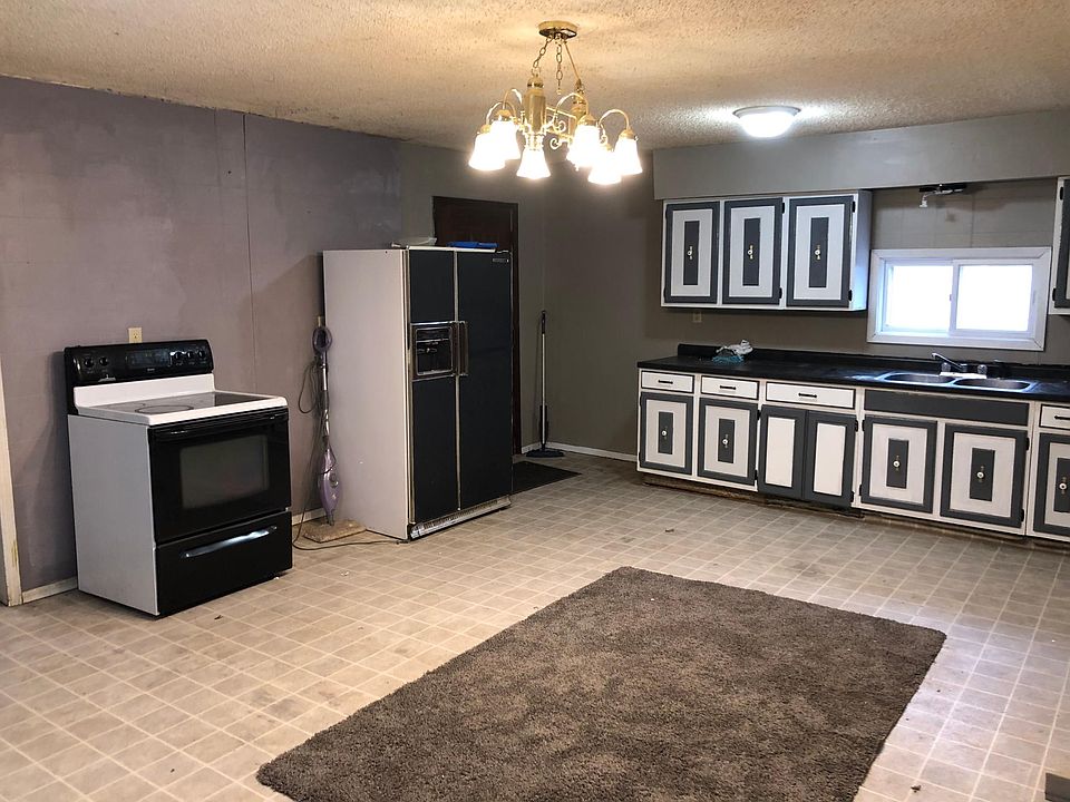 Large kitchen with stove and refrigerator 