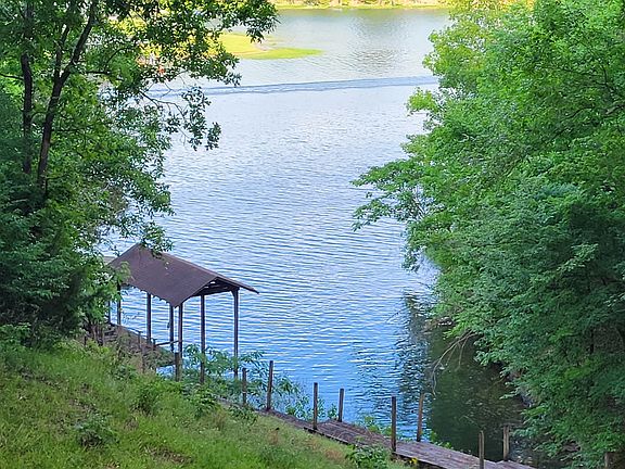 View from back porch, boat cover and large dock for swimming.