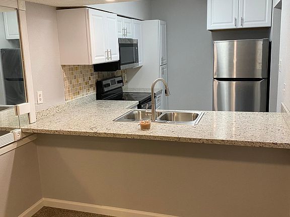 Ornamental Light Granite with custom backsplash. Deep sink with custom fixture and recessed lighting.