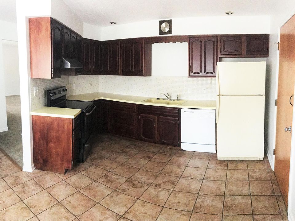 Kitchen with tile floor and a unique tile backsplash. Also i