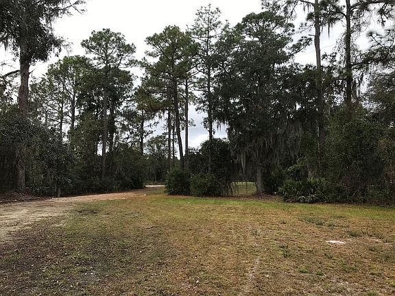 View of street and gravel driveway to the left.