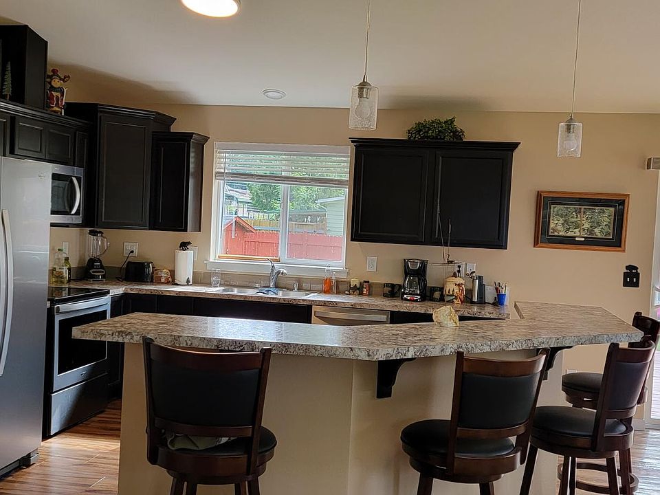Open concept kitchen opens to living and dining rooms.