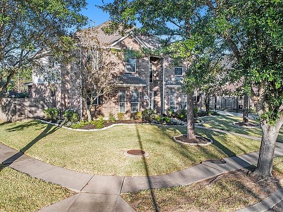 An expansive corner lot lined with mature trees!