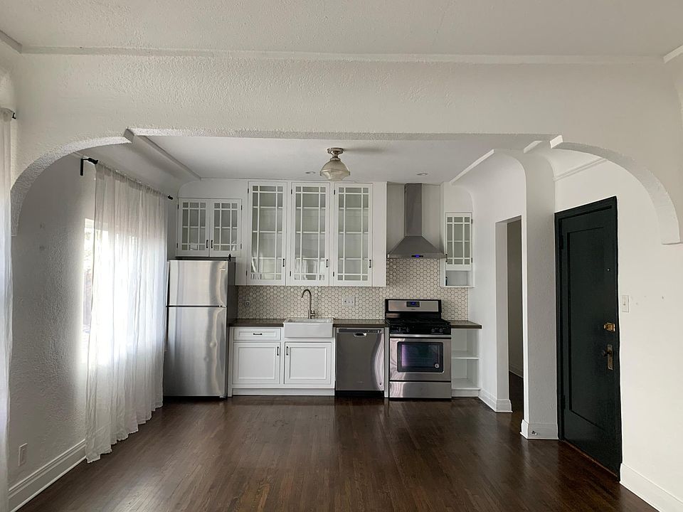 upper cabinets were salvaged from original built ins from the building. new appliances. dining area in front of kitchen.
