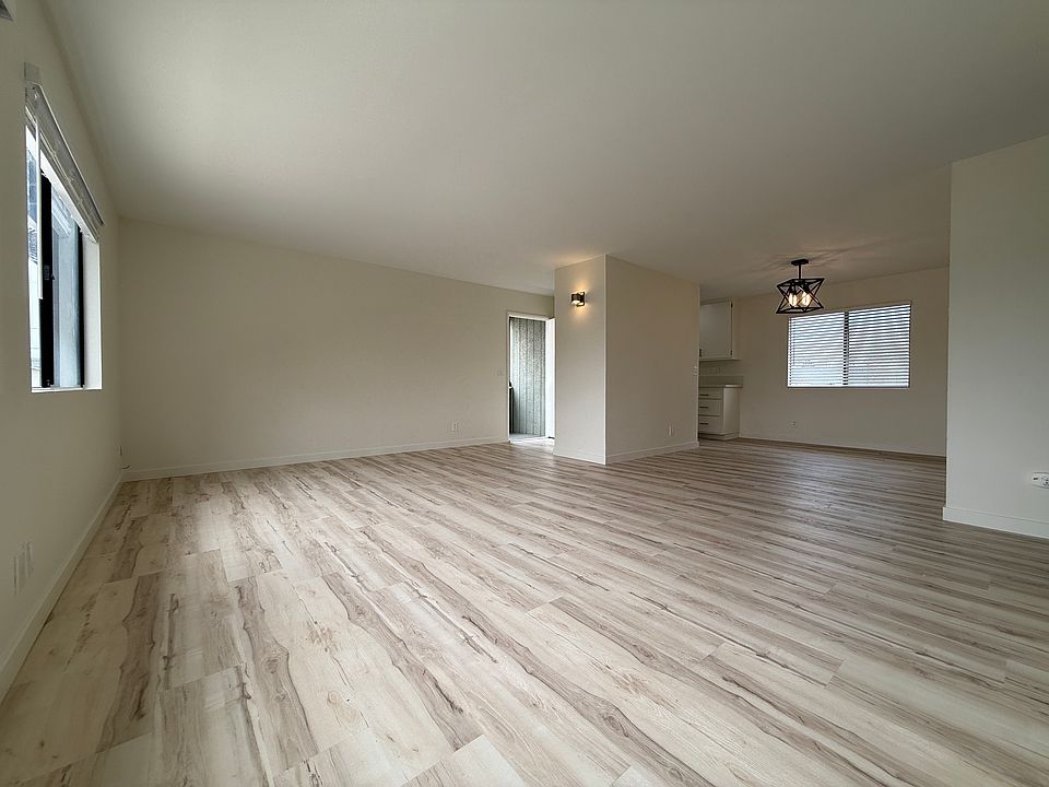 Living room back to front door to dining area, and kitchen