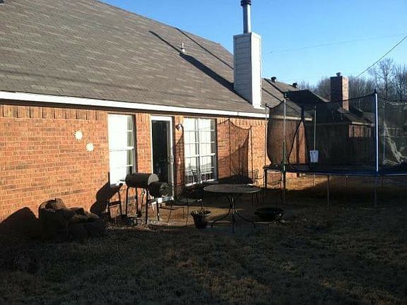 Fenced in backyard with patio