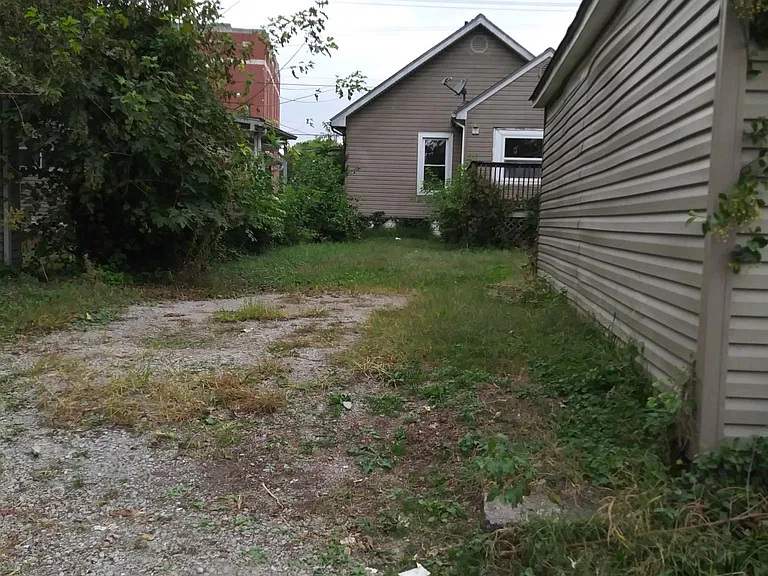 parking space next to garage looking at back of house