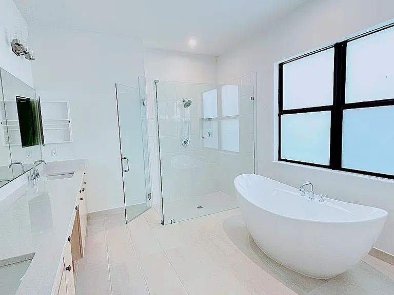 Master bath with his and her, and free standing tub and shower.