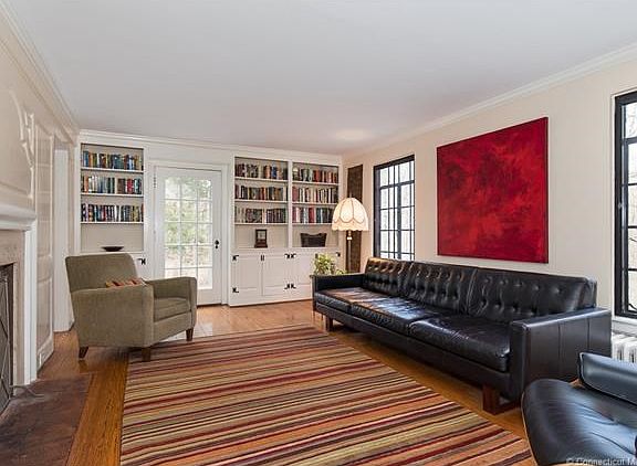 Living room with built-in book shelves and fireplace
