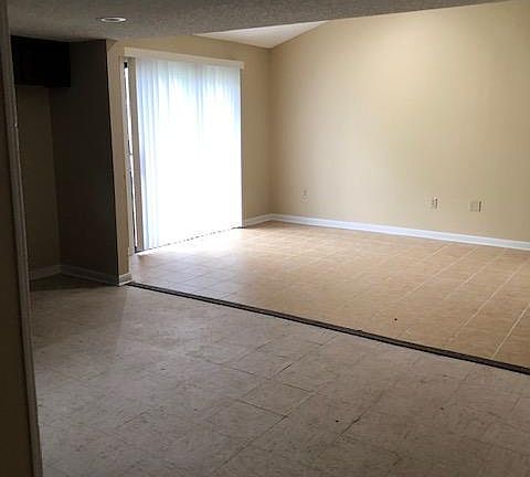 View from kitchen to back of family room with sliding glass doors to backyard