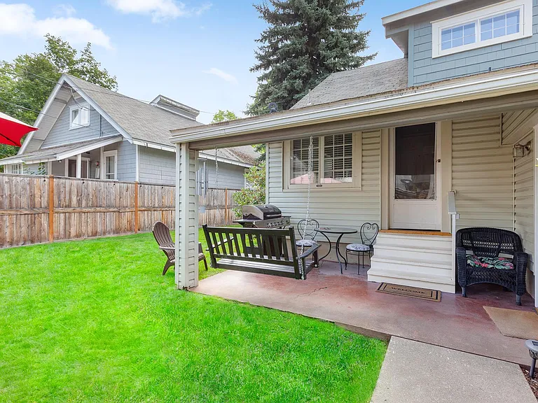 Back yard with BBQ and porch swing.
Fully fenced in yard.