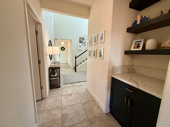 Hallway from entry to living room/great room - includes alcove with built-in