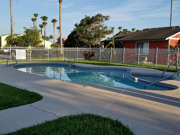Pretty, pristinely kept pool, lounge chairs,