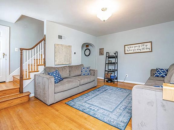 View of living room, coat closet, and stairs to 2nd floor, from the front door