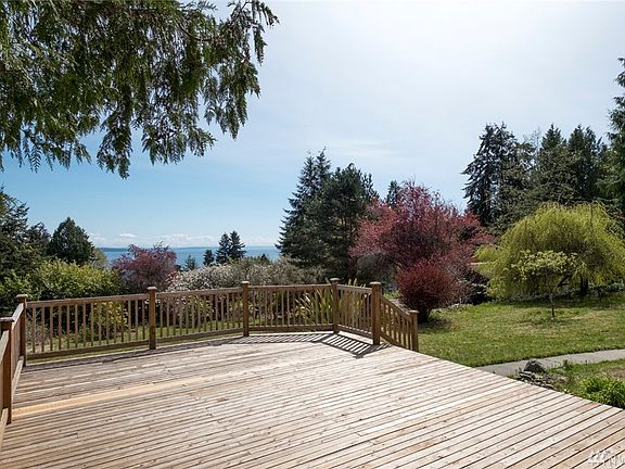 Beautiful views from the spacious front deck. A variety of colorful trees and shrubs on the property.