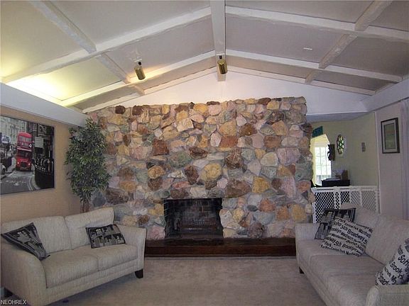 The livingroom is approx. 23 x 17 featuring a stone face fireplace and cathedral ceiling. On the back of the fireplace is the dining room with a entry on the right.