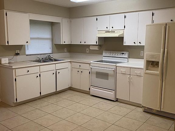 Large kitchen with refrigerator and new stove