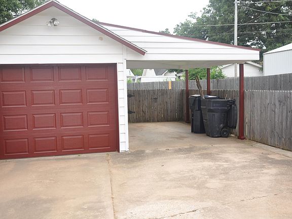 The carport adjacent to the garage allows a second car to be protected from the elements; there is a remote-controlled opener for the garage.
