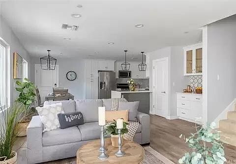 Living/great room with kitchen in background
