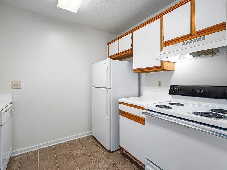Cook with ease in kitchens featuring warm wood cabinetry and complete appliance packages, professionally operated by Highlands Vista Group.