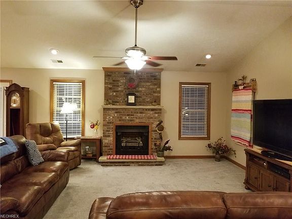 Cozy and spacious family room...enjoy the brick fireplace...with heat sensor...shuts off and turns on based on the room temperature you set.  Also includes a brand new fireplace insert.