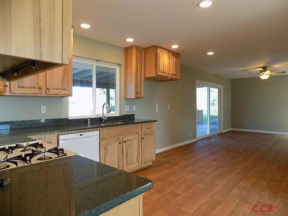 The kitchen is open to the family room and new sliding glass door that opens to the backyard and the pool.