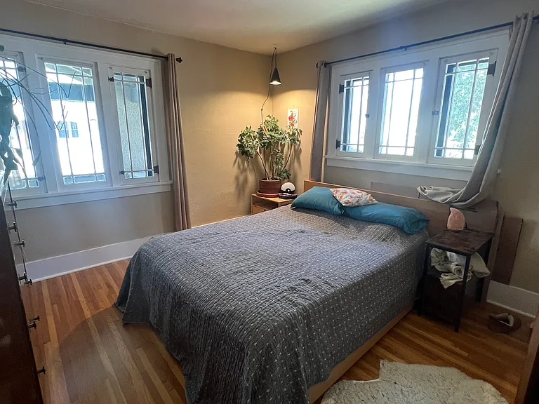 April 2026-Front bedroom with two large windows and functioning screens. This bedroom faces the front porch. Easily fits this queen bed.