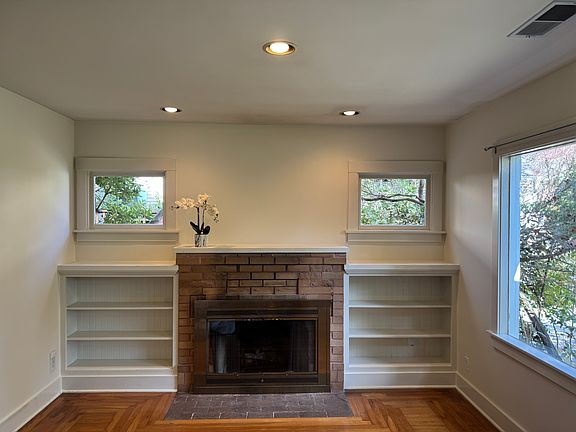 Fireplace flanked by two built in bookcases