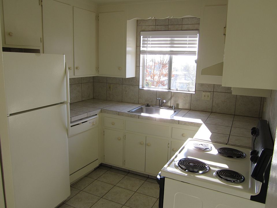 Enter home thru security gate and entry door, & kitchen is on your left with a lot of cabinet space, frost-free refrigerator, dishwasher, sink with window looking over lovely scenery, range w/self-cleaning oven ~ ez to prep your gourmet or every day food