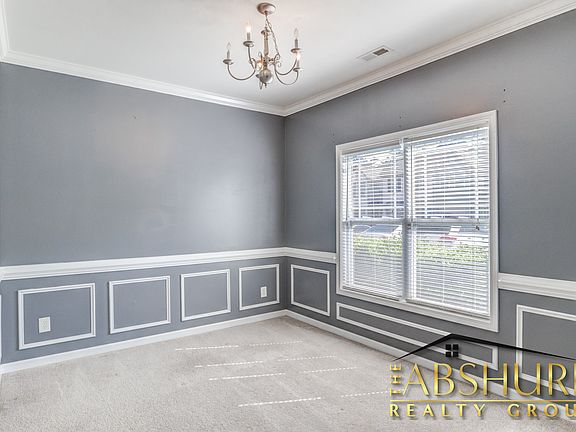 Formal Dining Room with Crown Molding and Wainscoting
