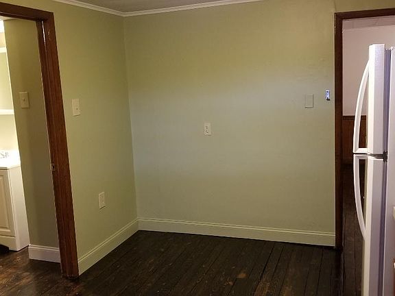 Kitchen, with bathroom door on the left, dining room entrance on right