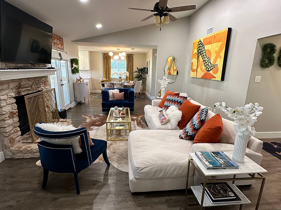 Living room has vaulted ceilings and lots of natural light.
