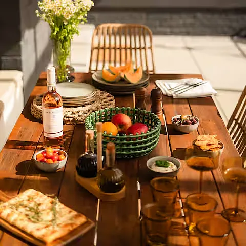 Inviting patio with a stylish outdoor dining area and comfortable seating, perfect for alfresco meals, morning coffee, or relaxing evenings.