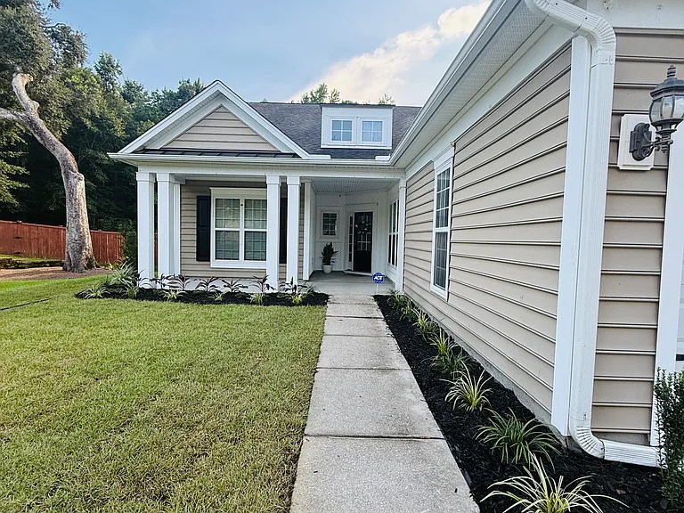 Welcome to Carolina Bay! This stunning home boasts exceptional curb appeal, a spacious two-car garage, an extra-wide driveway, and a charming front porch nestled against a peaceful, wooded backdrop."