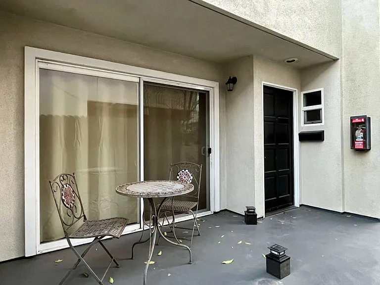 Front entrance of unit 6, sliding doors and front door into home