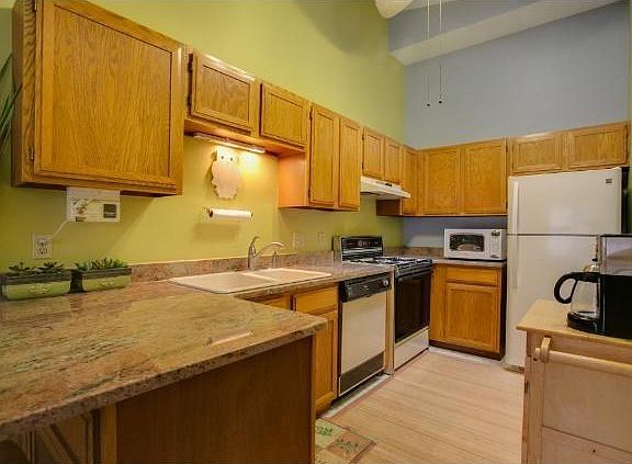 Large kitchen with skylight, newer appliances (not pictured), natural stone countertop