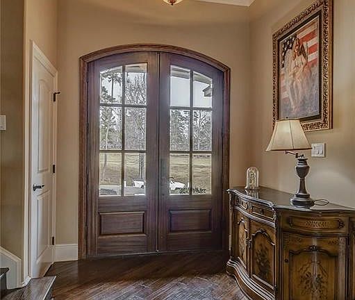 Watch the sun rise through these beautiful double mahogany doors leading into the entry way.  Front entrance over looks the 17th fairway.