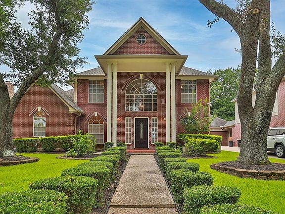 This beautiful home boasts stately columns and tons of curb appeal