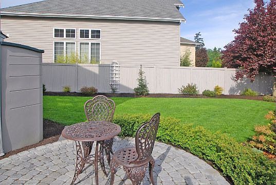 Beautifully landscaped fully fenced backyard with cobblestone