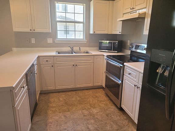 Kitchen with extra large Frigidaire refrigerator, GE dual oven, and Thermador Sapphire Glow diswaher