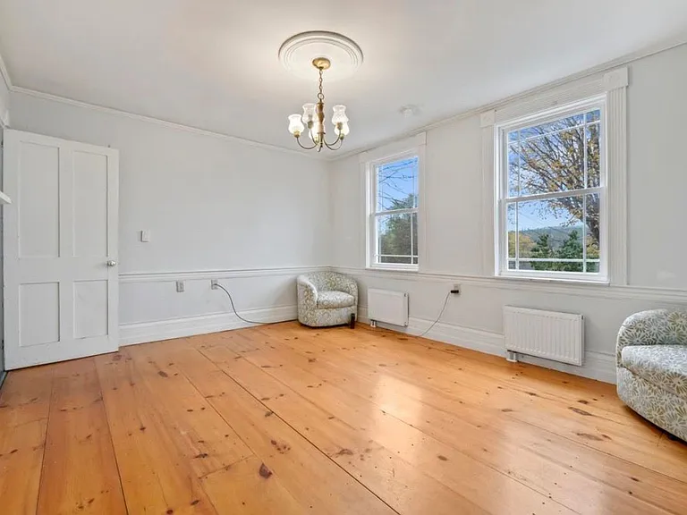 The living room has a beautiful view of the water with plenty of natural sunlight