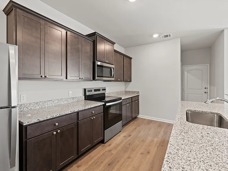 The kitchen has sprawling granite countertops.