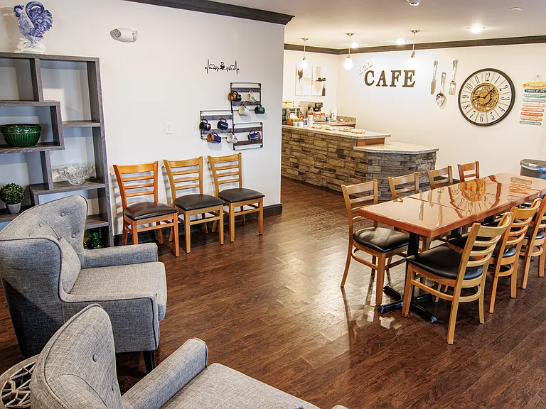 Inviting cafe and gathering space with a fireplace, perfect for enjoying a coffee, snack, and conversation with neighbors