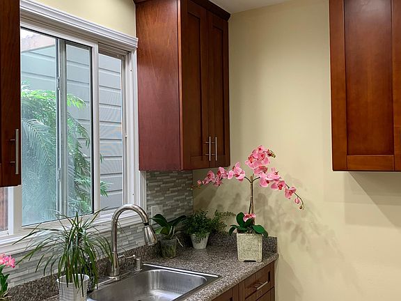 Kitchen sink with dishwasher looking into the