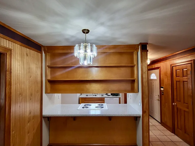 Custom shelves and storage in kitchen and dining area. Apt. 2A