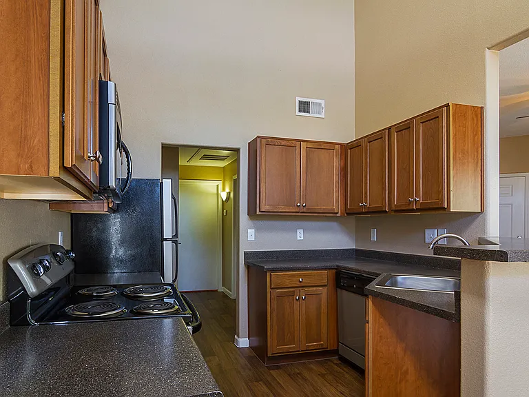 Kitchen with dark laminate counters and dark walnut wood cabinets