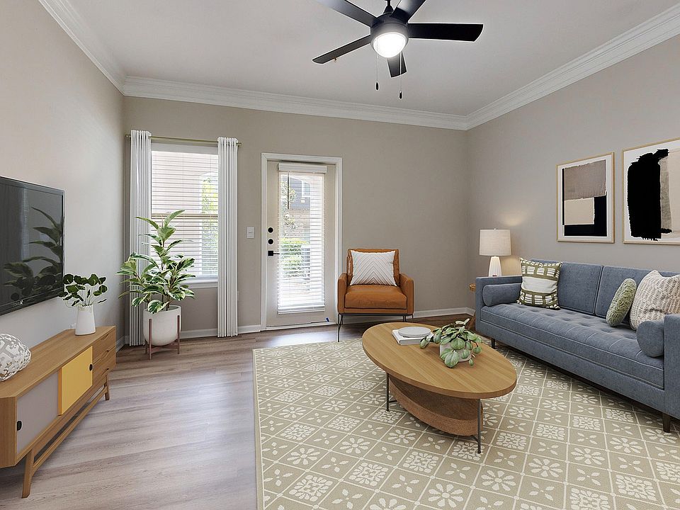 Large living room with hardwood style flooring and patio.
