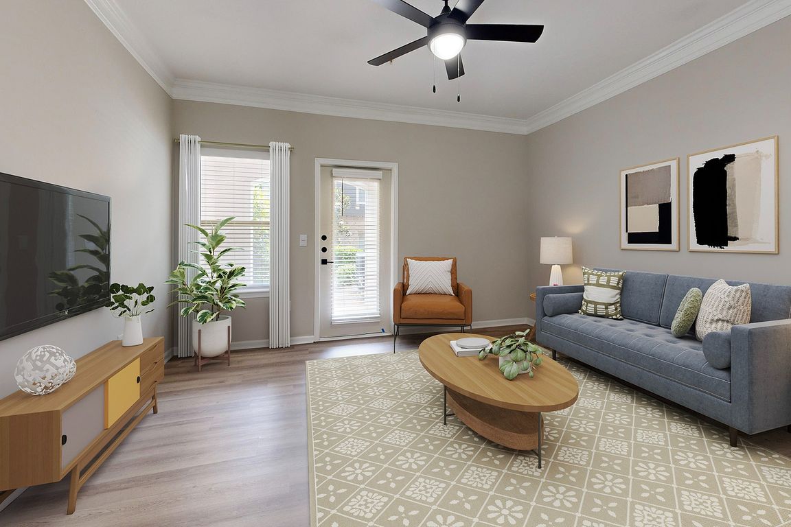 Large living room with hardwood style flooring and patio.