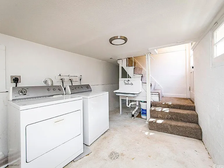 large laundry well lit 
room with washer and dryer