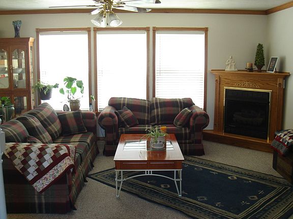 family room with gas fireplace, oak moldings, custom lighting througout.